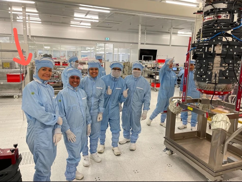The team in the cleanroom, giving thumbs up